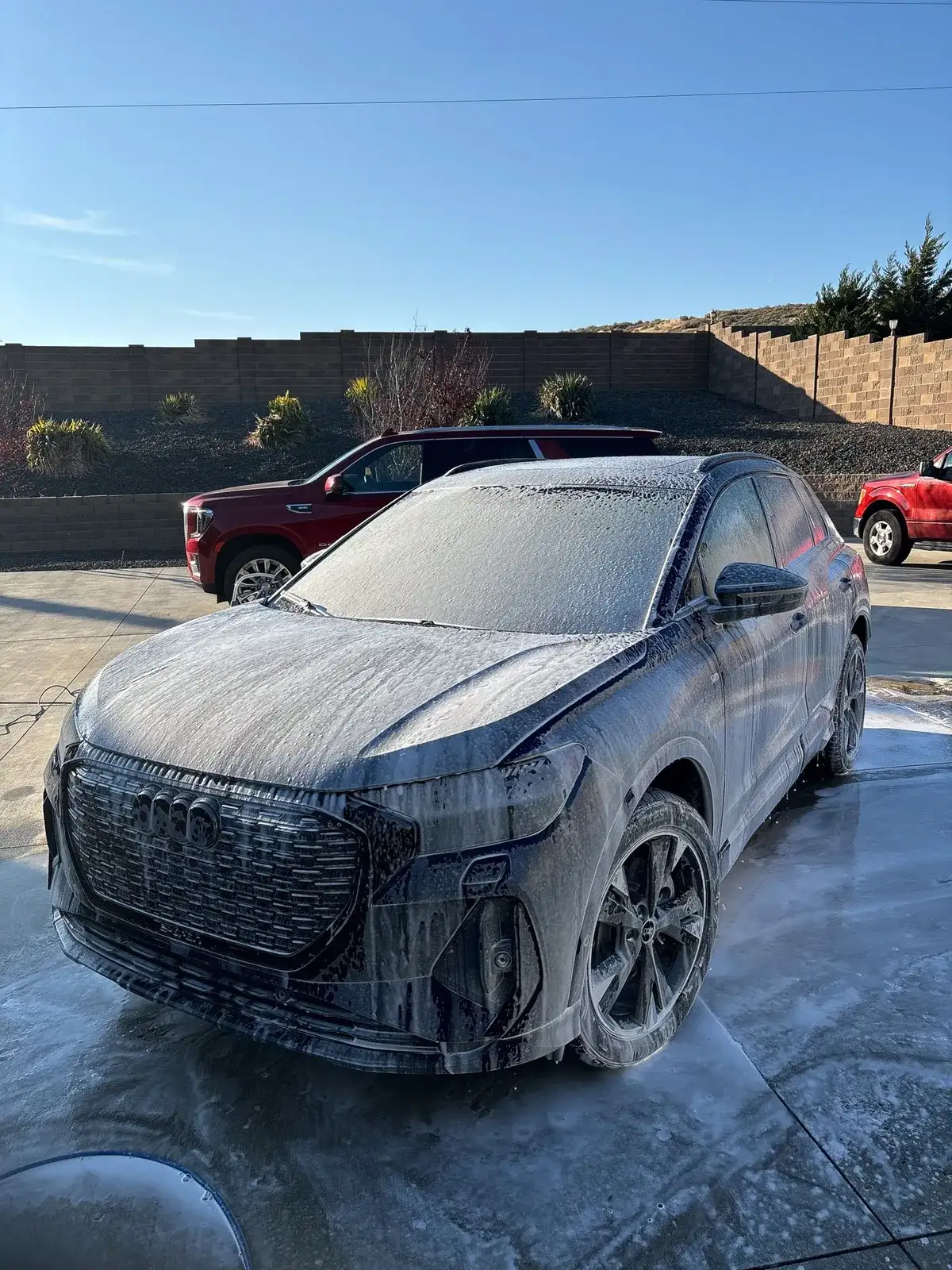 An Audi SUV covered in thick foam during a Premium Exterior Detail