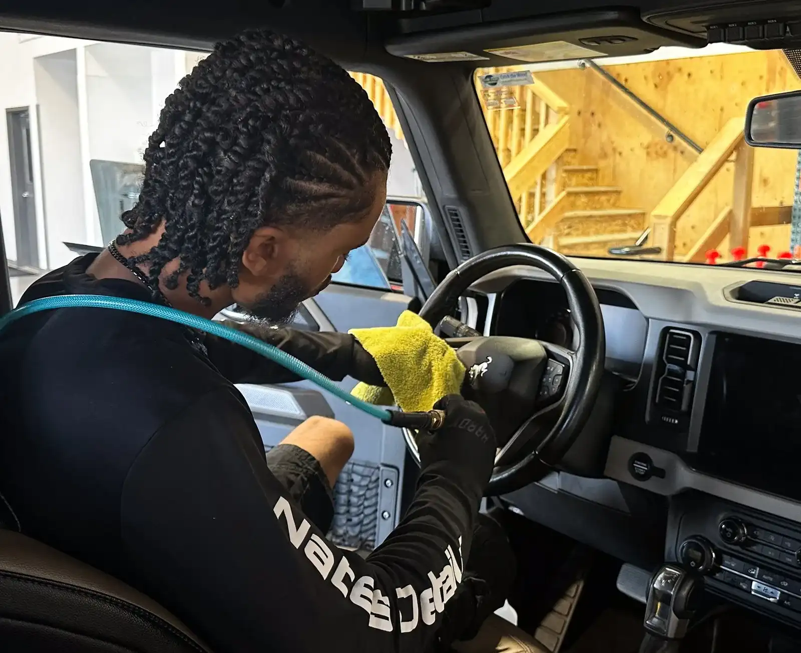 Nate cleaning a steering wheel during a Premium Interior Detail