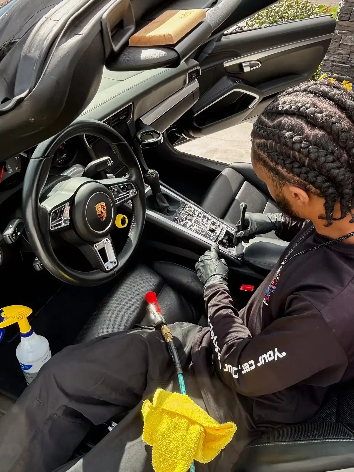Nate detailing the interior of a Porsche 911