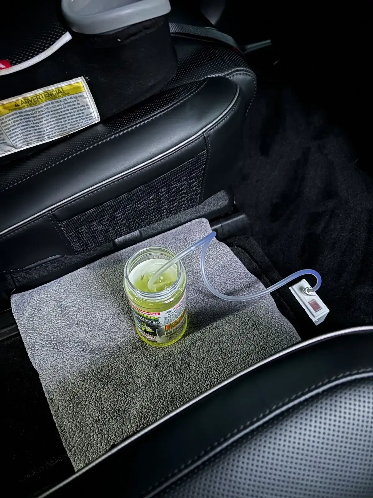 An odor treatment set up on a towel inside a vehicle