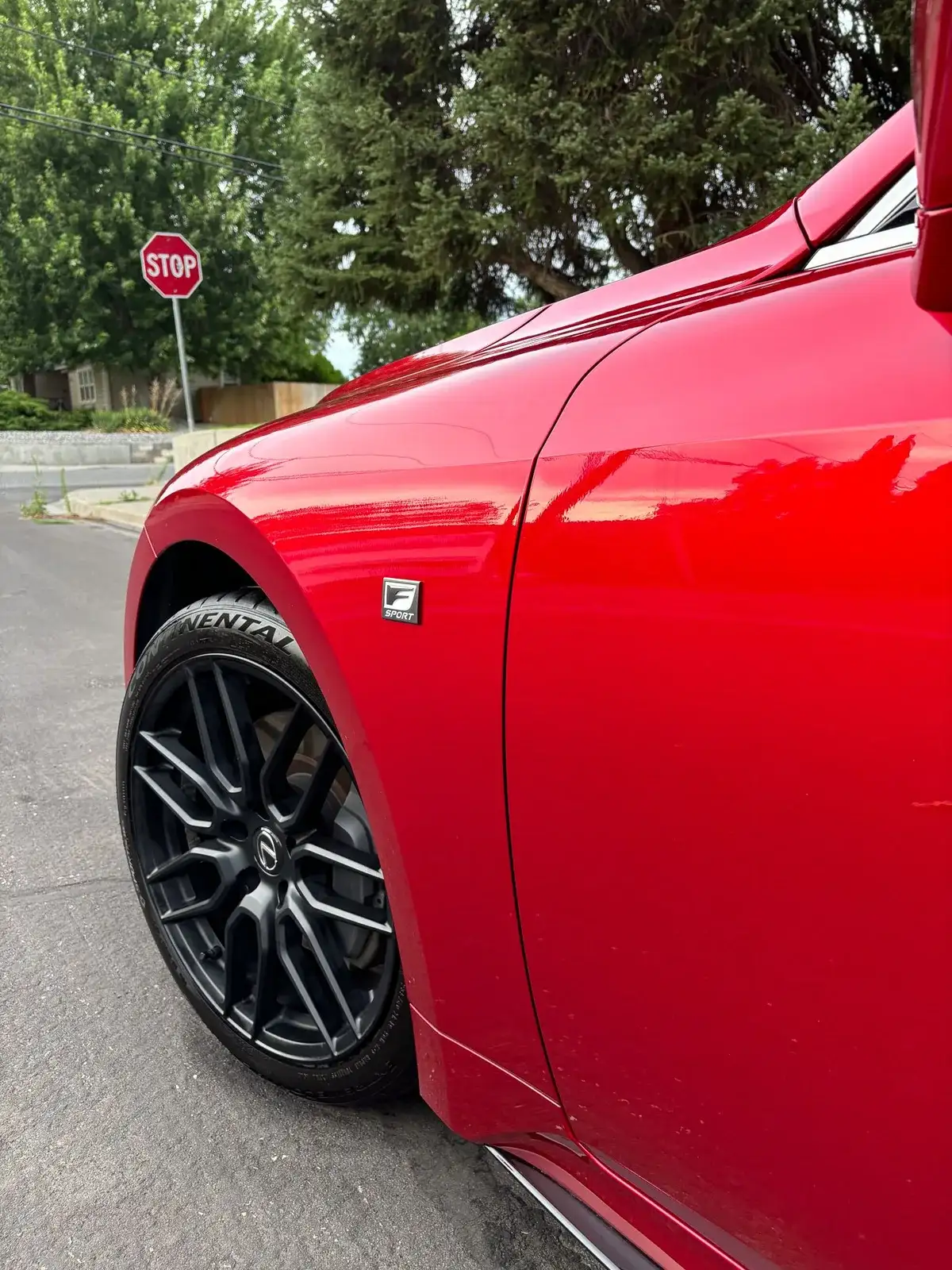 Glossy red Lexus fender and wheel after wax-sealant protection